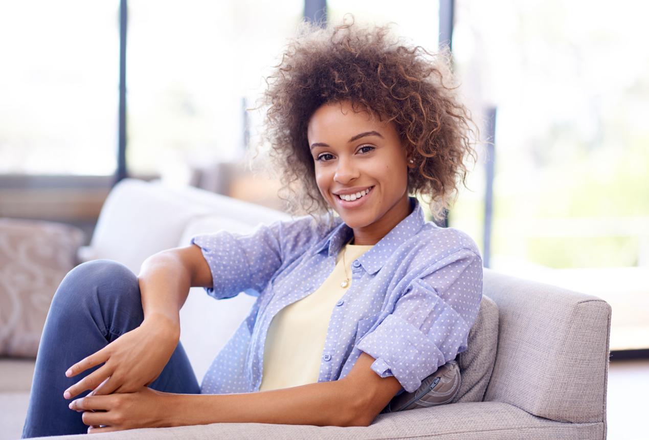 Happy homeowner relaxing after selling their property as-is